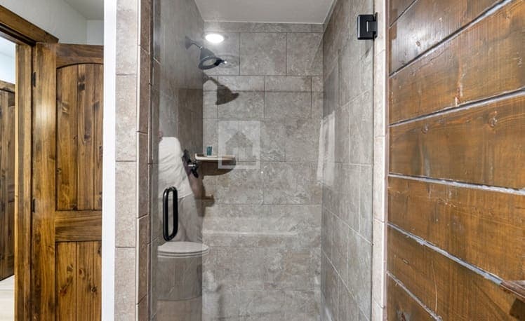 Tiled glass shower in the primary bathroom