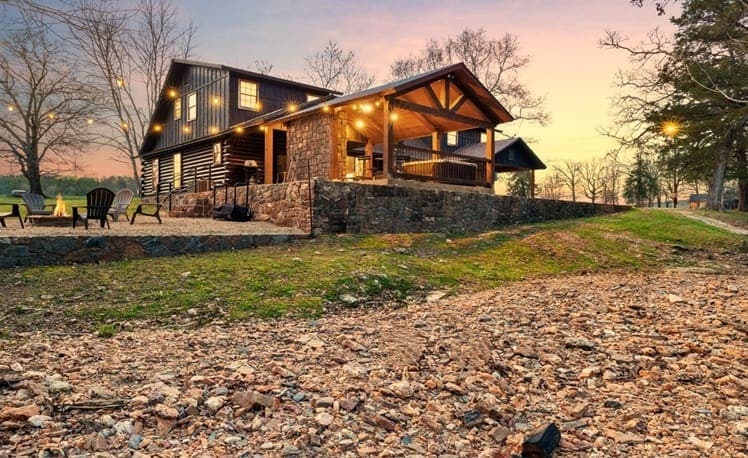 Creek at dusk with string lights overhead