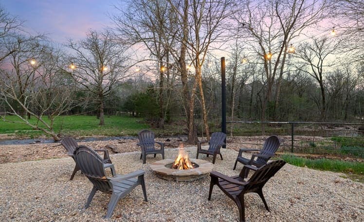 Fire pit at dusk with string lights lit up